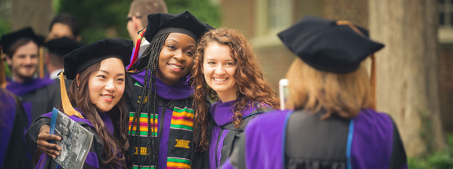 Graduates pose for photographs during a commencement ceremony of Regent University, which believes in developing Christian leaders who will impact the world.