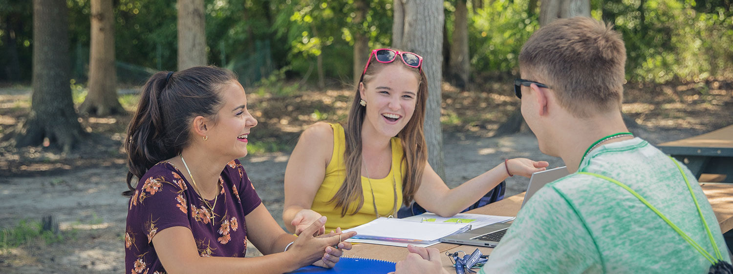 A group chatting at Regent University, Virginia Beach.