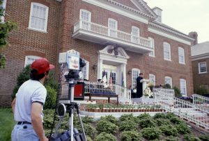 Dr. Pat Robertson delivers an address to a past class of Regent University on the steps of the Administration Building.