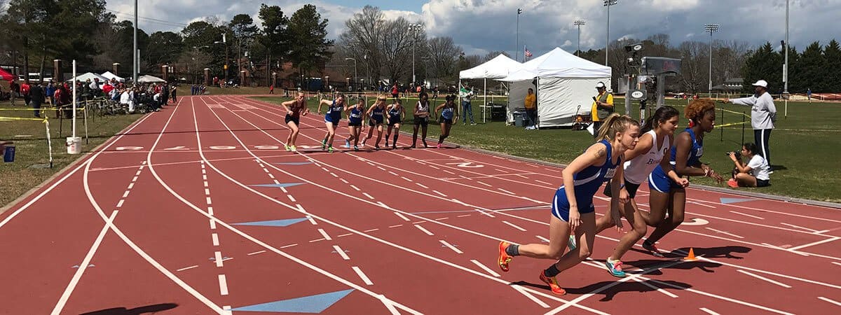 Regent University's Track and Field team members at a competition.