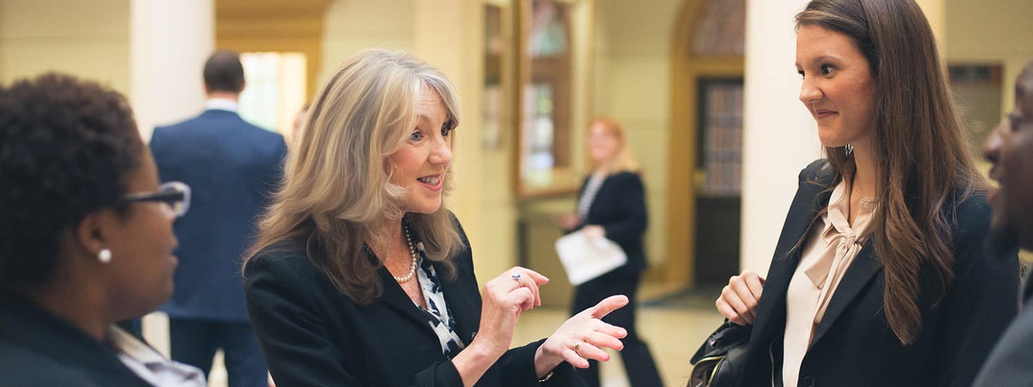 A law professor chats with students.