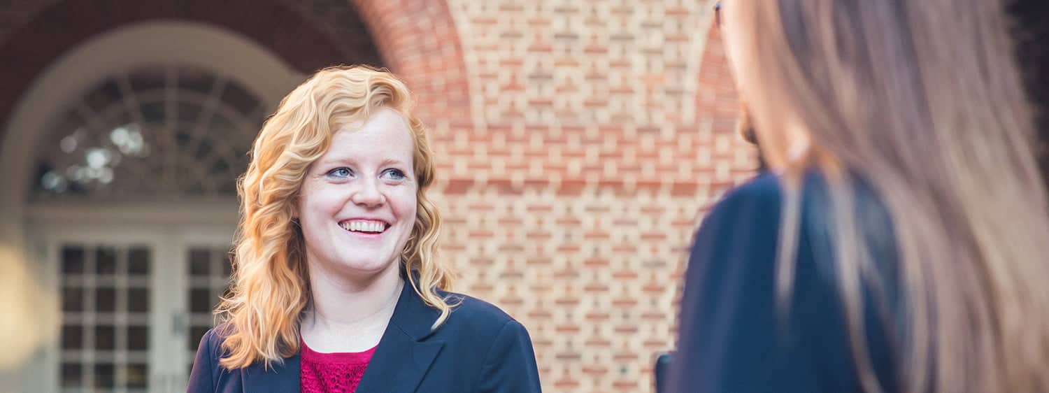 Two students smiling and discussing the M.A. in Law Nonprofit Degree at Regent University.