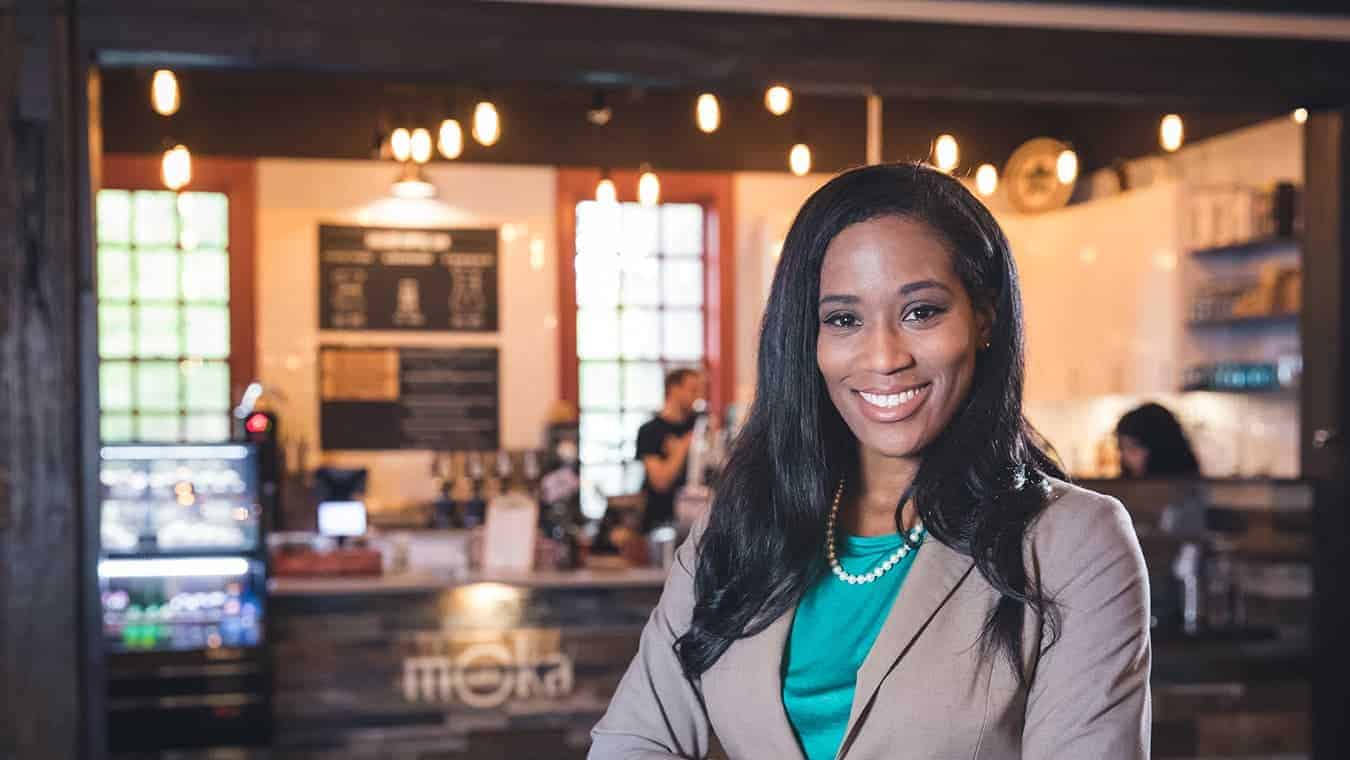 A headshot of an alumna of Regent University's MAOL degree program in the campus coffeehouse.