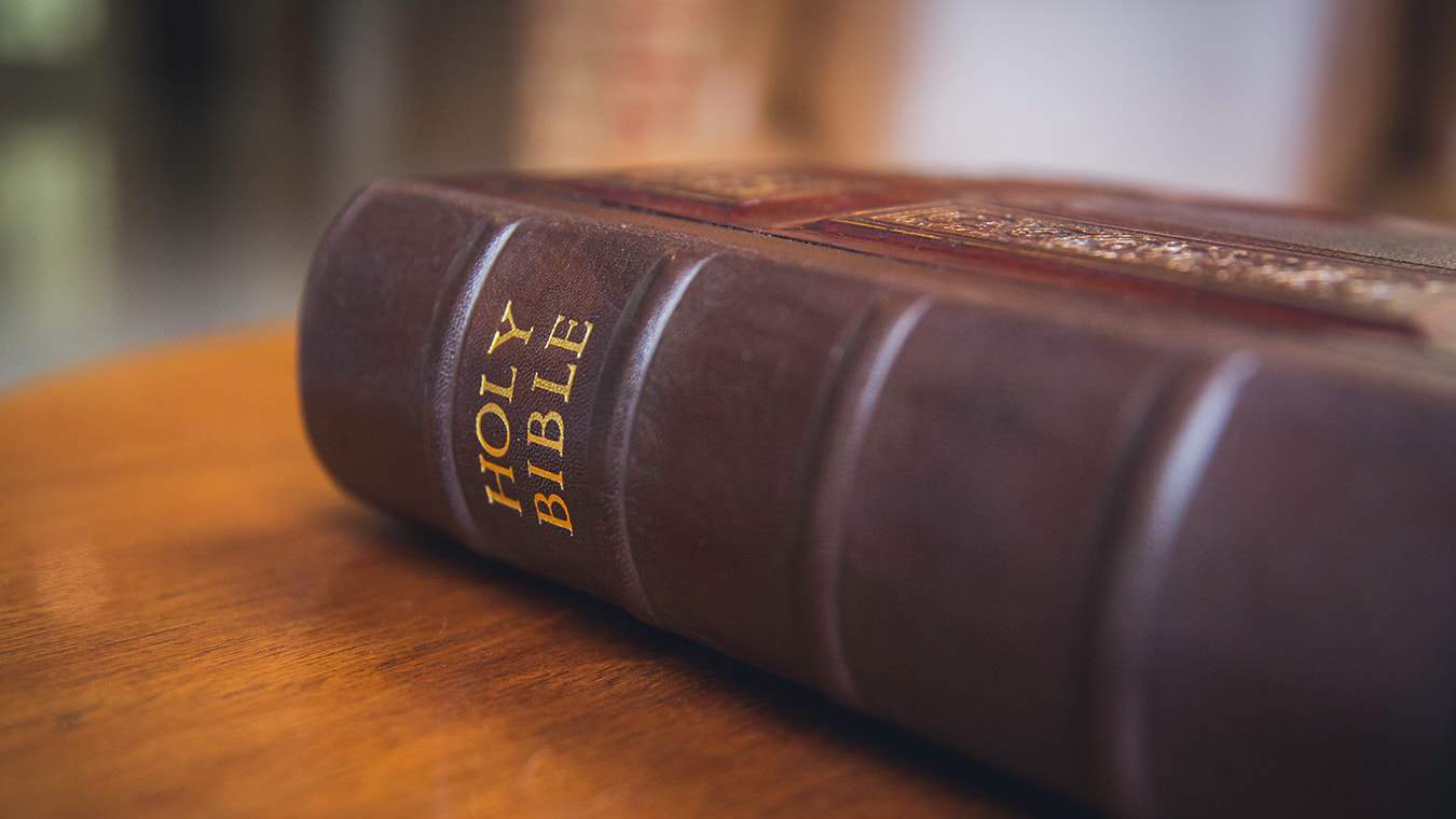 A closeup of the book spine of the Holy Bible that is used in the MDiv in Theology & Ministry - Christian Theology degree program at Regent University.