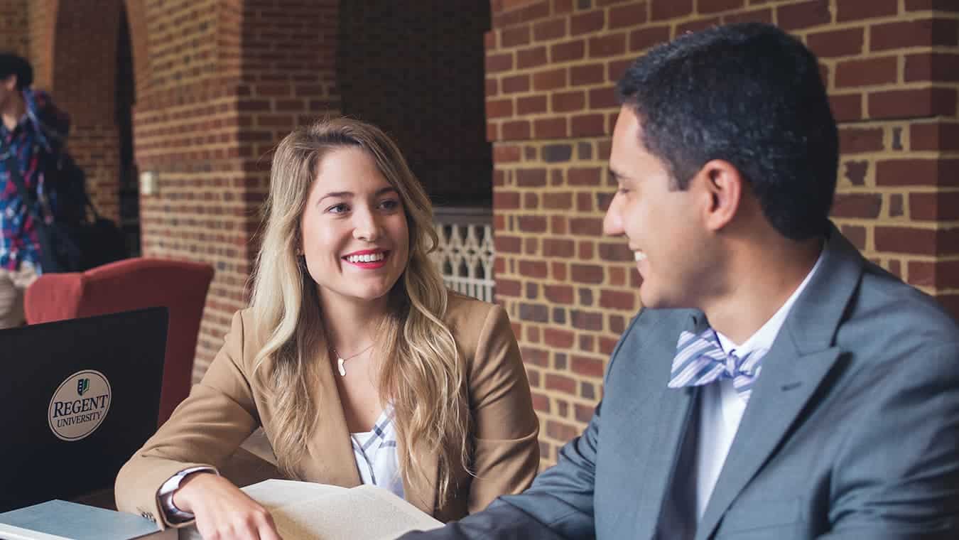 Graduates at the library: Explore the MPA Emergency Management and Homeland Security program offered by Regent University.