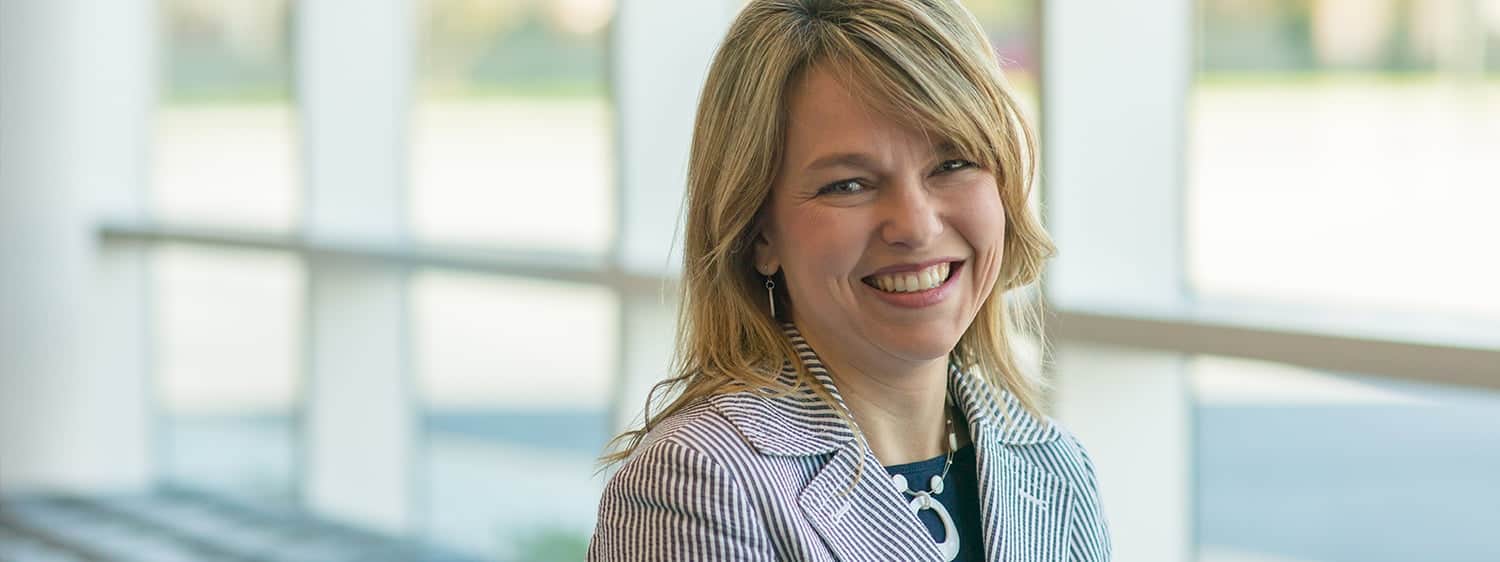 A headshot of an alumna of the M.Div. in Theology & Ministry - Spiritual Formation degree online at Regent University smiling in the Divinity building