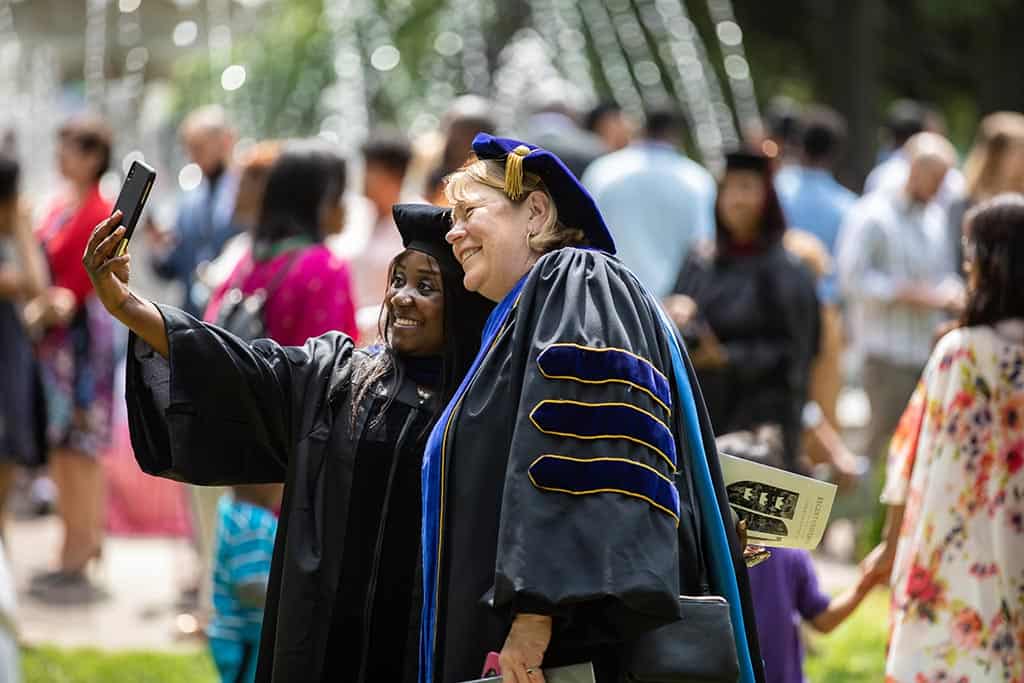 Celebrating friendship during Regent University’s commencement ceremony.