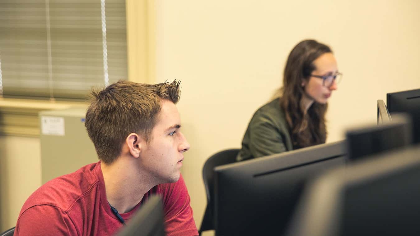 Students looking at their computer screens: Regent University offers an animation minor on campus in Virginia Beach, VA 23464.