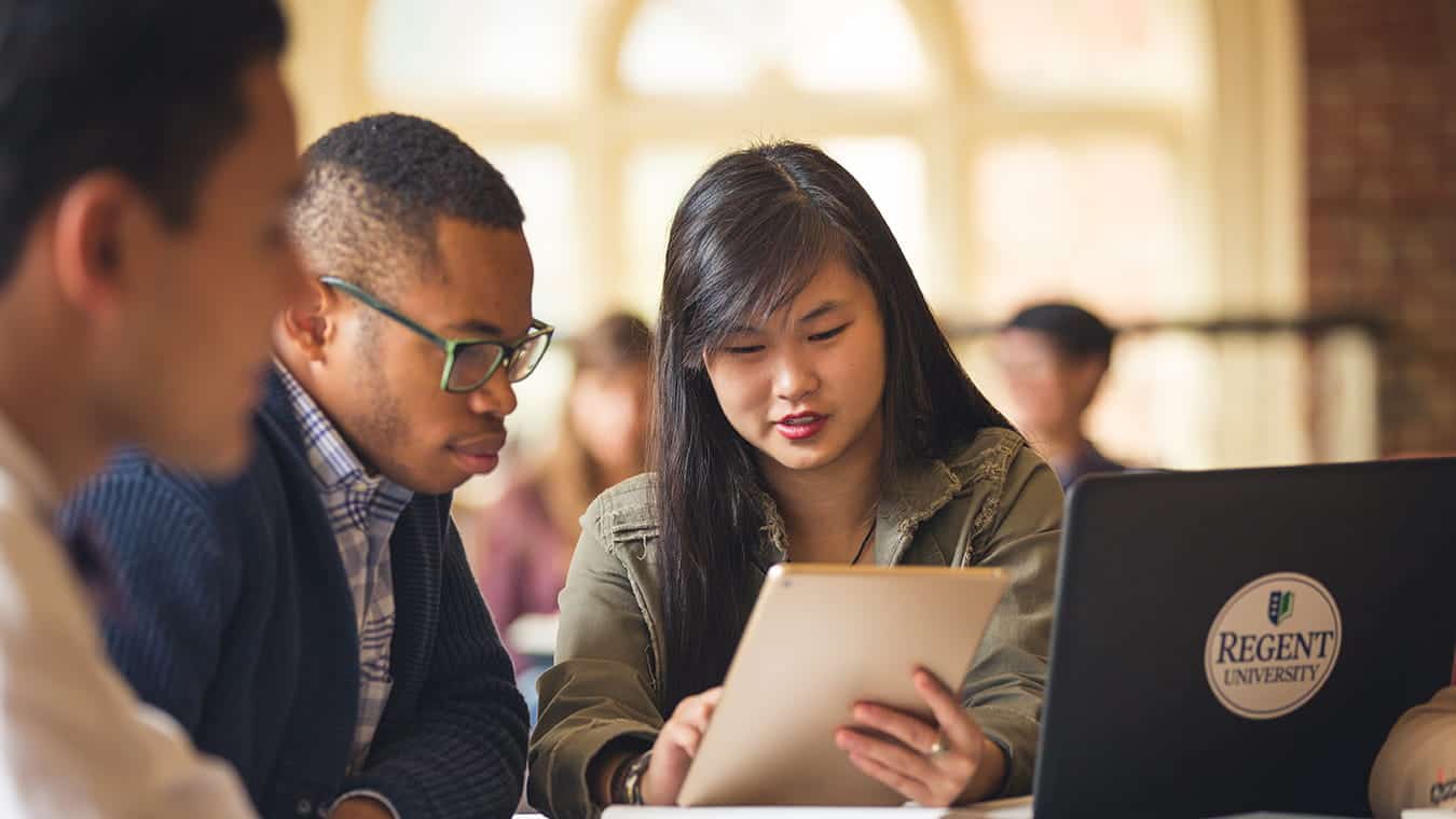 Graduates at the library: Explore the Bachelor of Science in Professional Studies - Teacher Education degree program offered by Regent University.