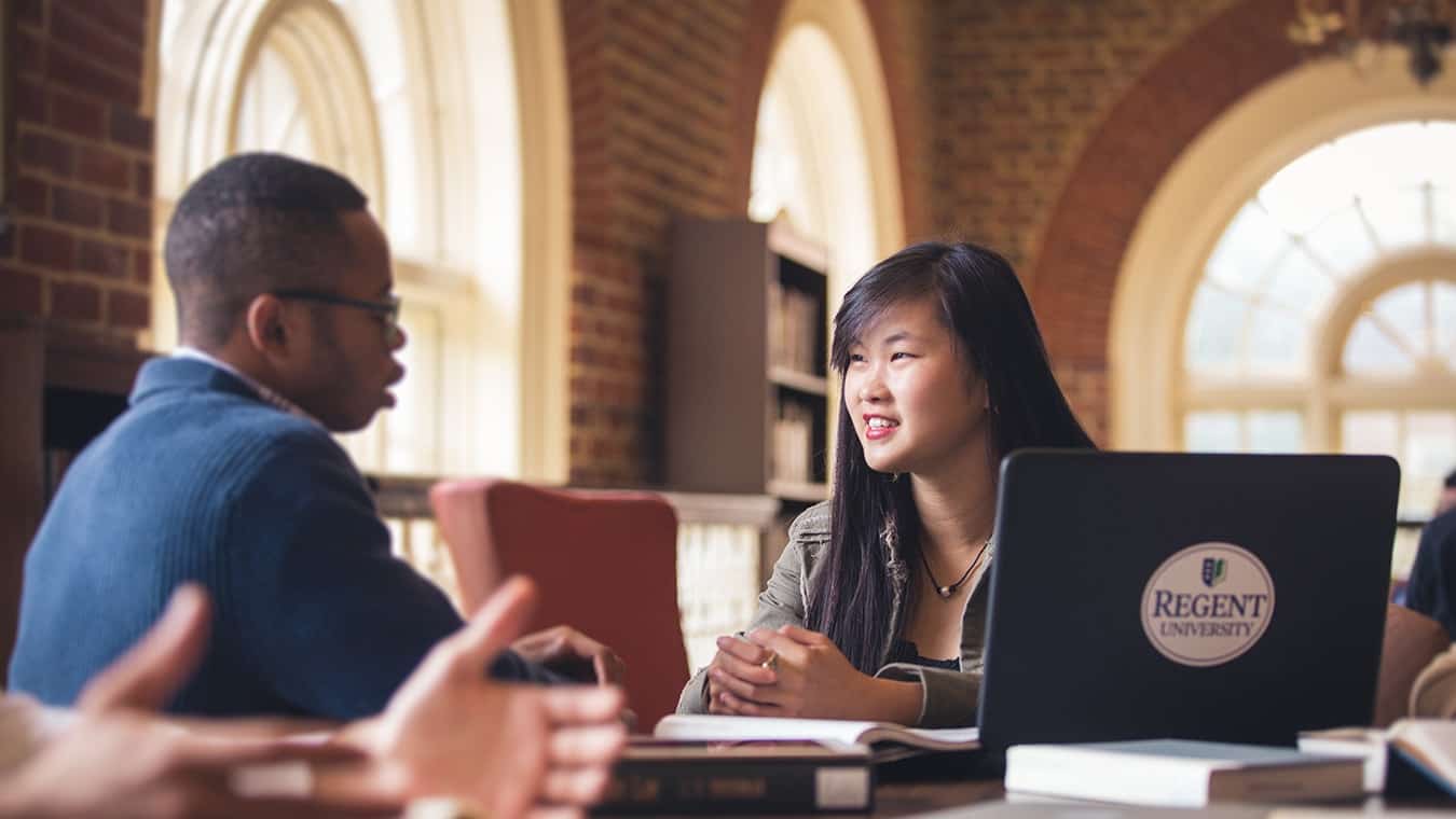 Graduates at the library: Explore Regent University’s online leadership minor.