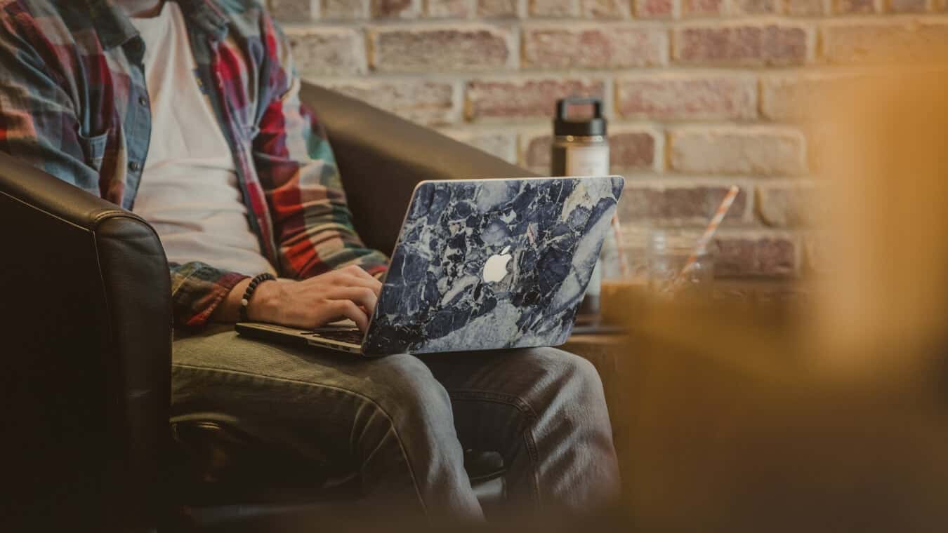 A person works on his laptop.