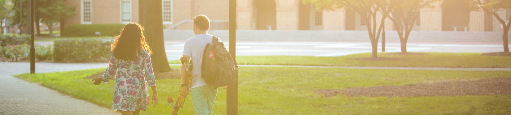 Two students walking on Regent University's campus during the summer in Virginia Beach, VA.