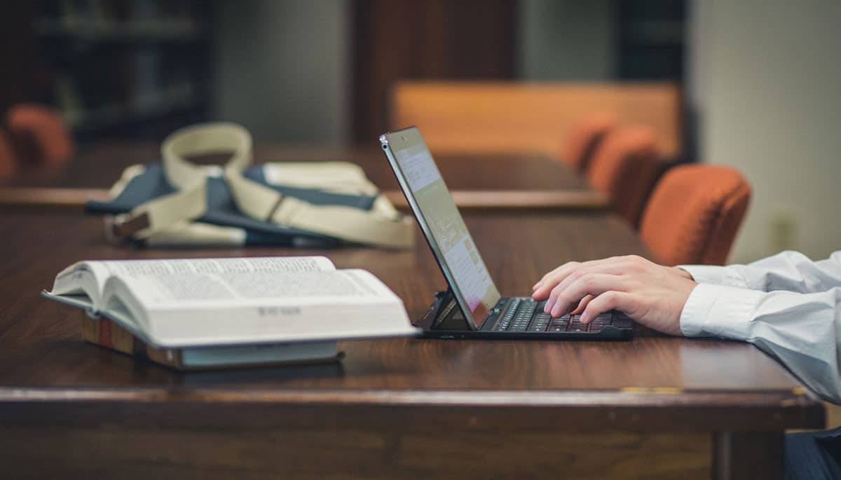 A person works on his laptop at the Regent University library in Virginia Beach.