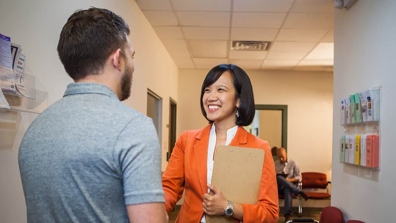 A visitor being greeted: Pursue a doctorate in coaching online at Regent University.