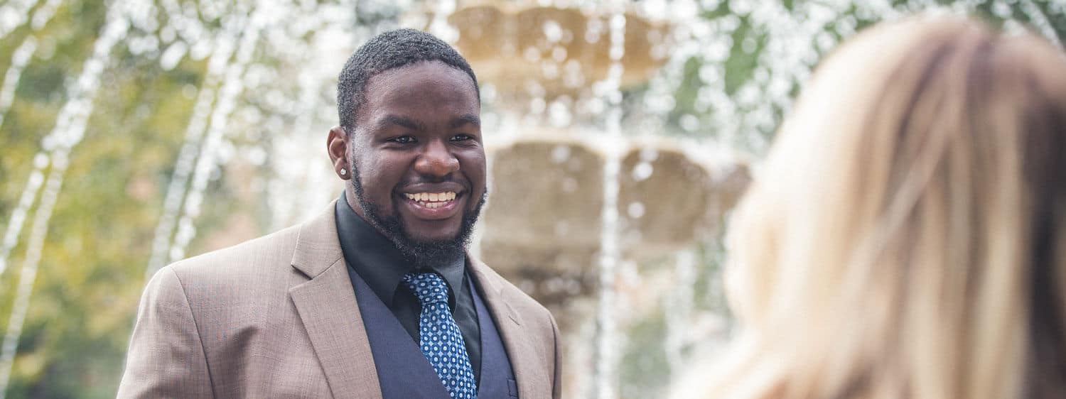 Regent University Student On Campus by Fountain in Suit