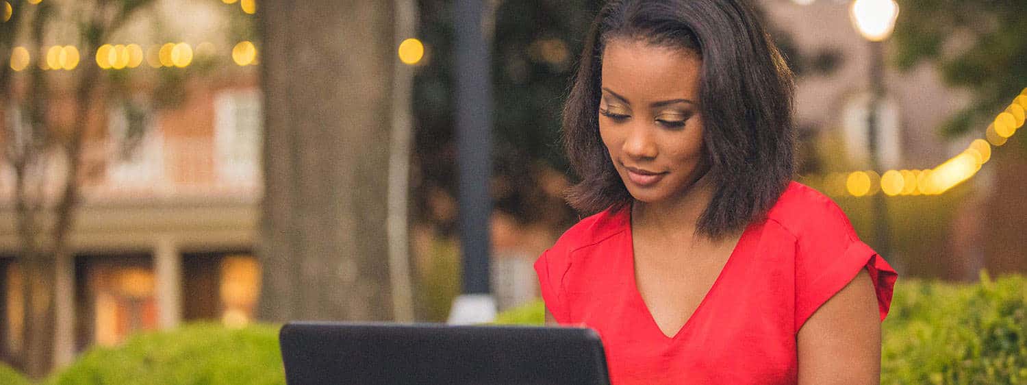 A student looks at her laptop at Regent, a premier Christian university that offers a SuccessPath Scholarship.