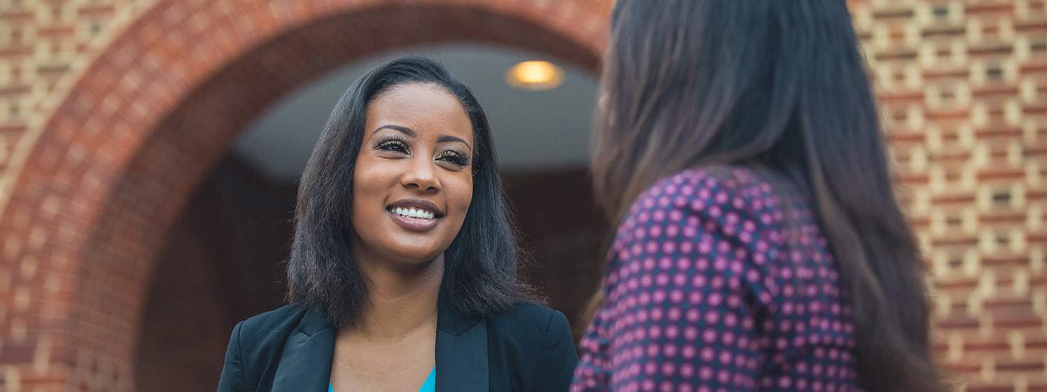 Two ladies chat at Regent University, Virginia Beach.