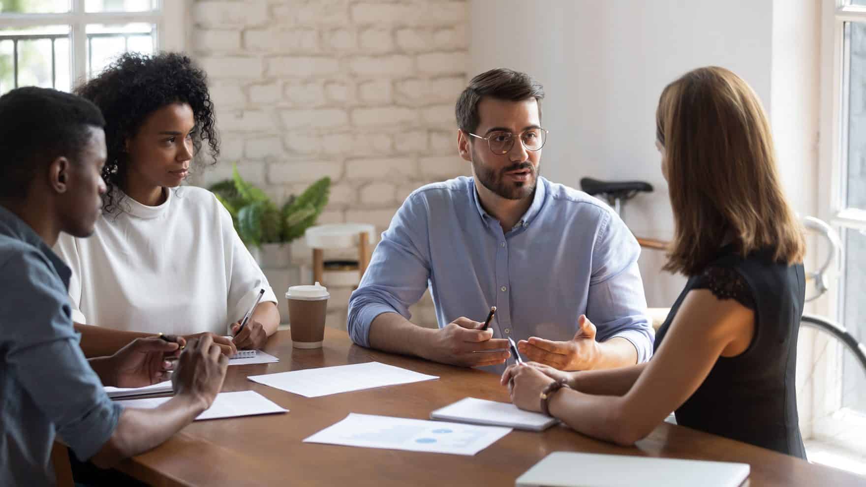 A person talking to a group: Explore leadership coaching.