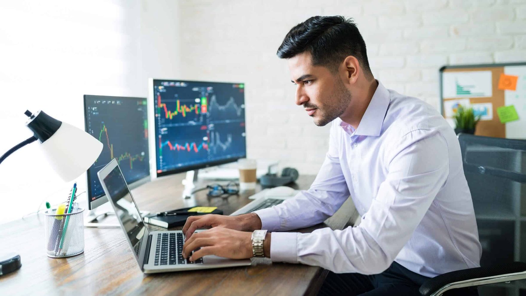 A person working on his laptop: Explore the master's in accounting at Regent University.