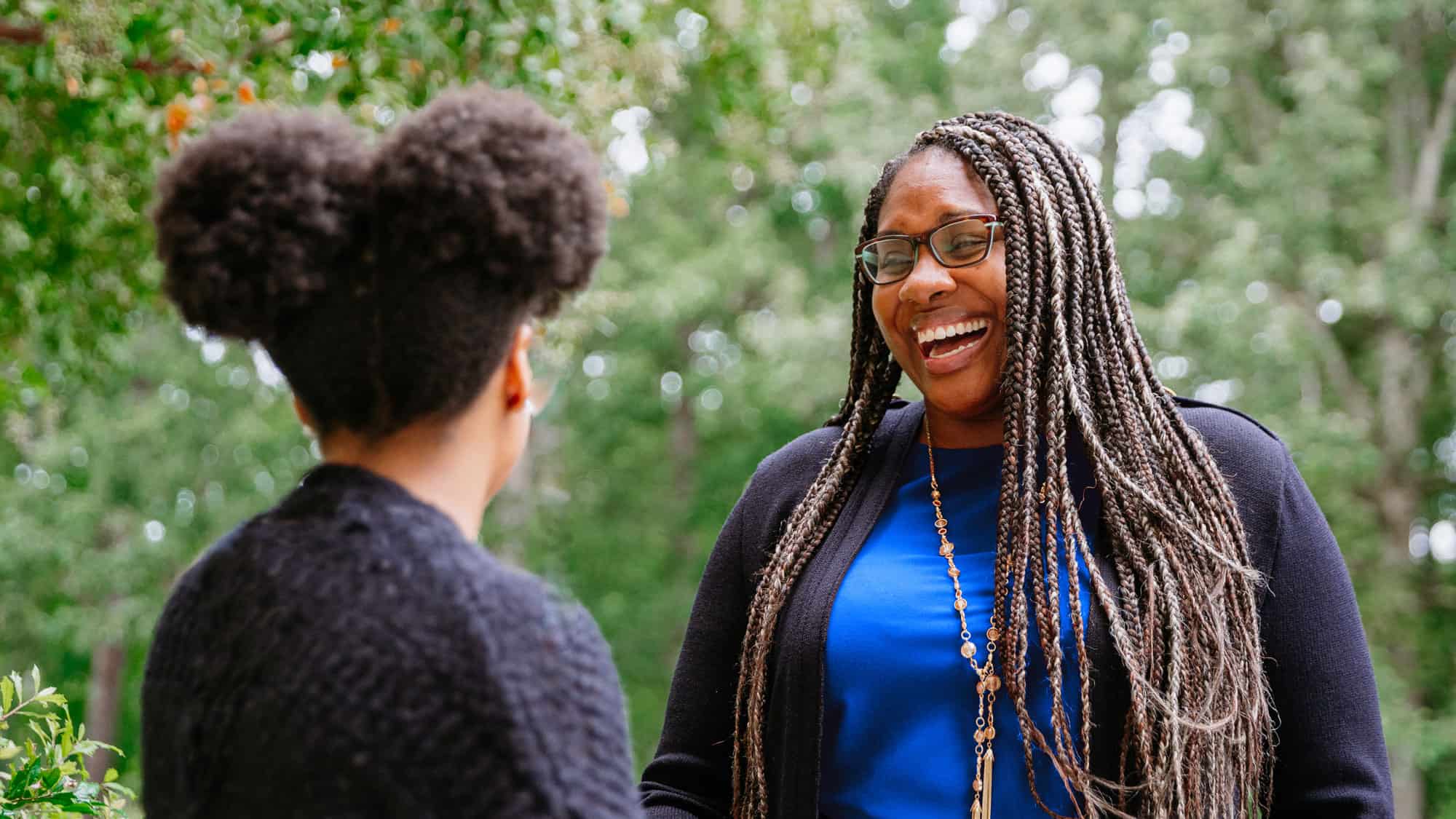 Two people laugh while talking in Virginia Beach.