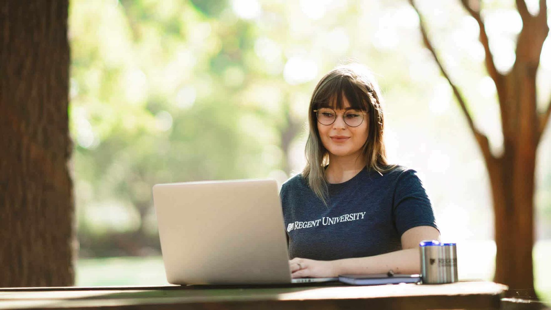 A girl with her laptop at Regent, a university that offers an MA in Screenwriting degree program.