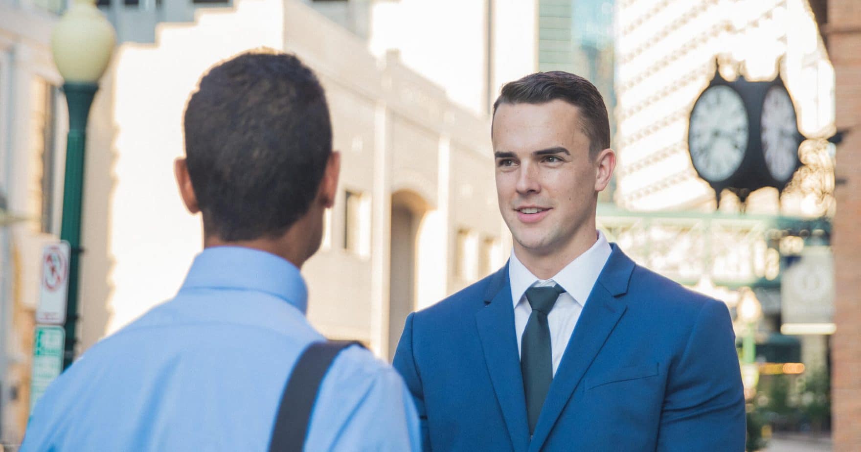 Two Regent University MBA students having a discussion outside in a city