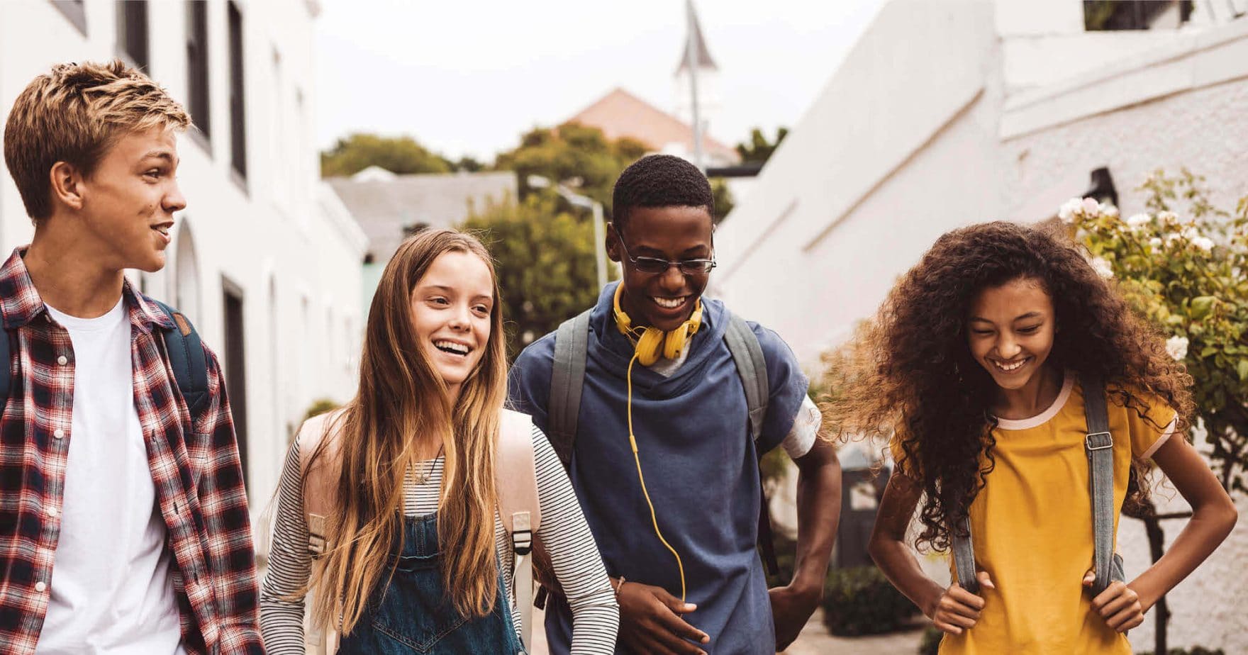 High school students walk to their early college class.