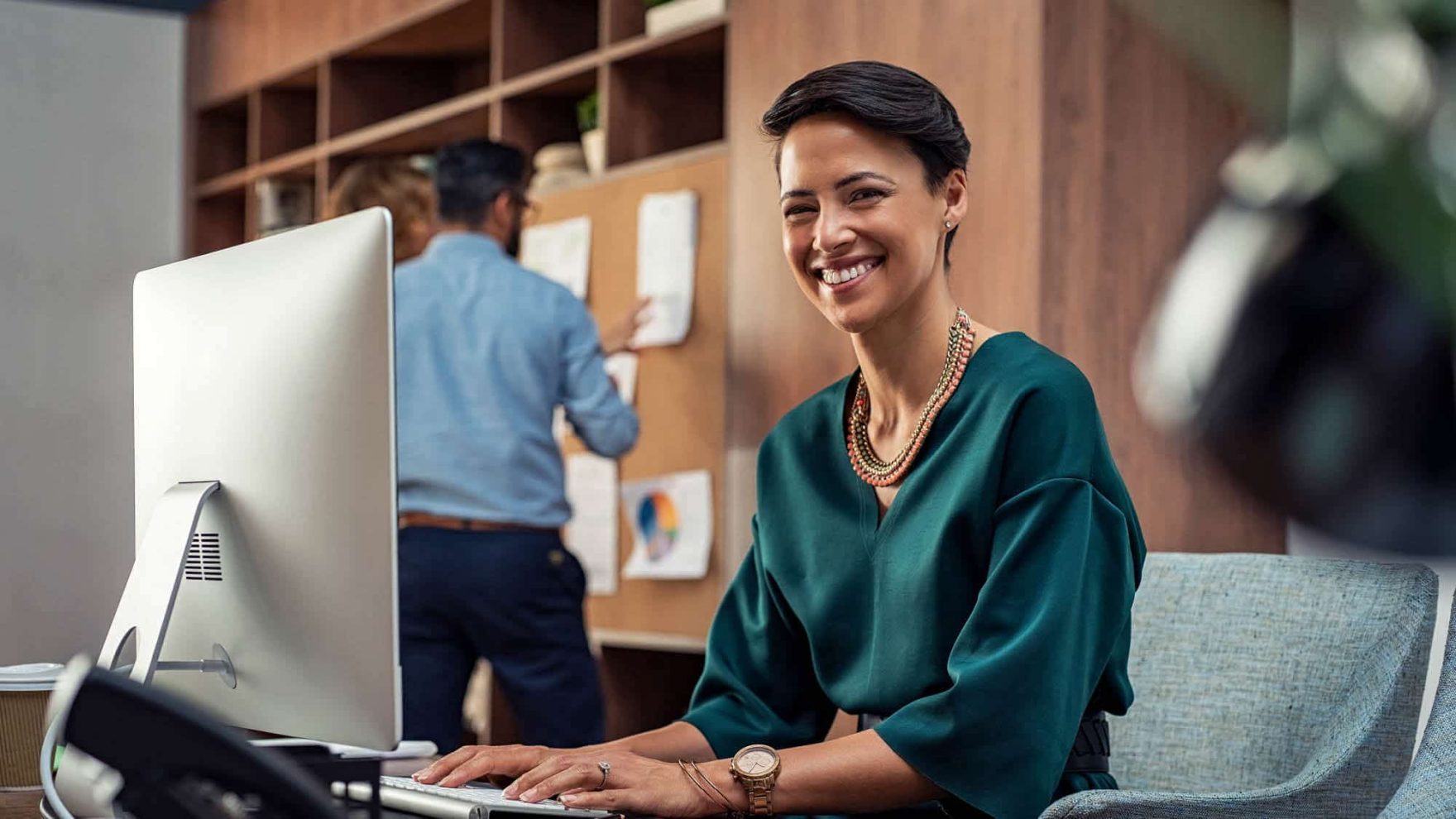 A lady smiles while her colleague looks at charts: Explore the new Ed.D, dissertation option.