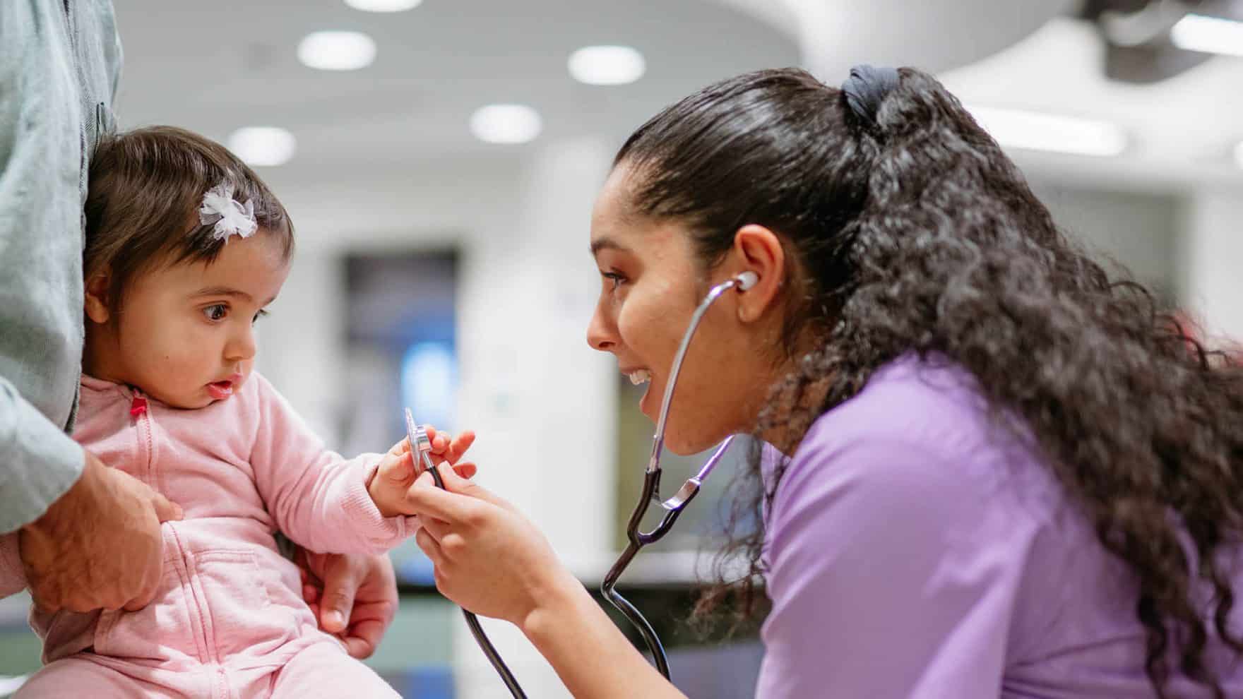 A nurse with a child: Explore the msn aprn fnp at Regent University.