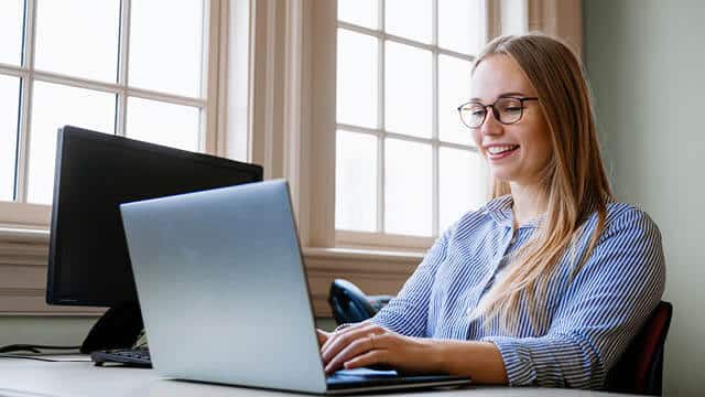 A student working on her laptop.