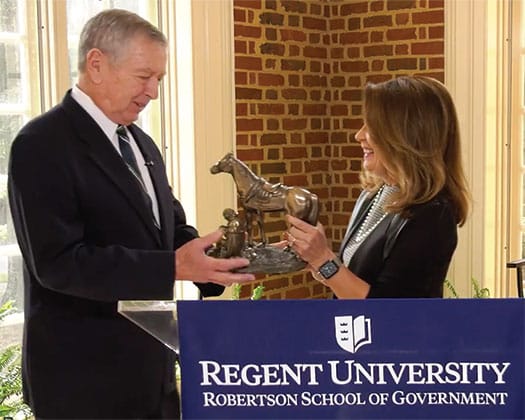 Dean Bachman gives General Ashcroft the Distinguished Statesman Award. 