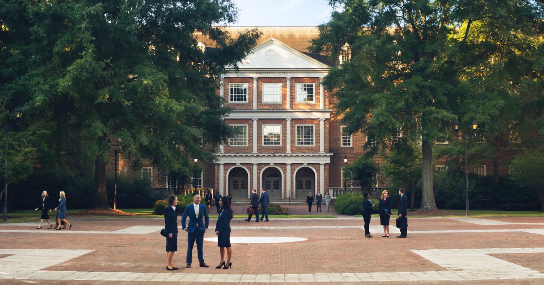 Regent University law students talking on campus after the School of Law earns high marks in PreLaw Magazine.