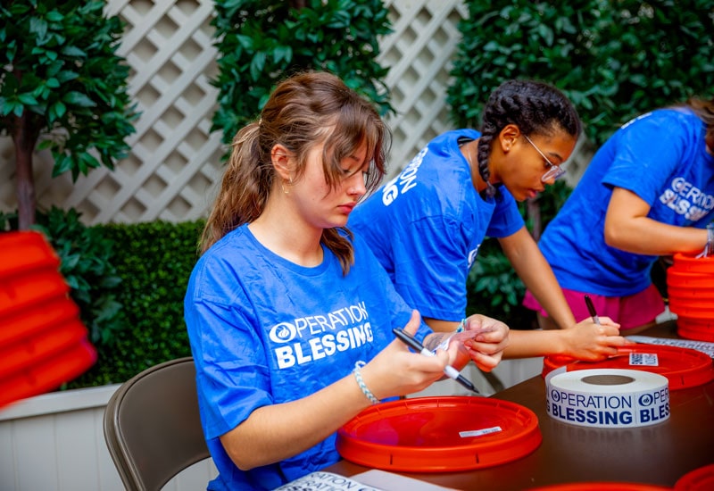 Regent Students and Operation Blessing pack disaster relief kits for Hurricane Idalia victims