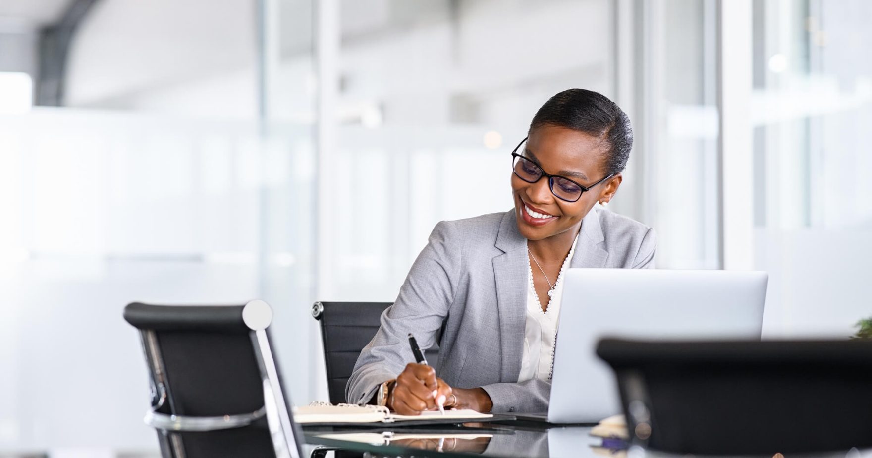 Businesswoman working on a laptop: Learn more about Regent's DBA and Ph.D. in Business.