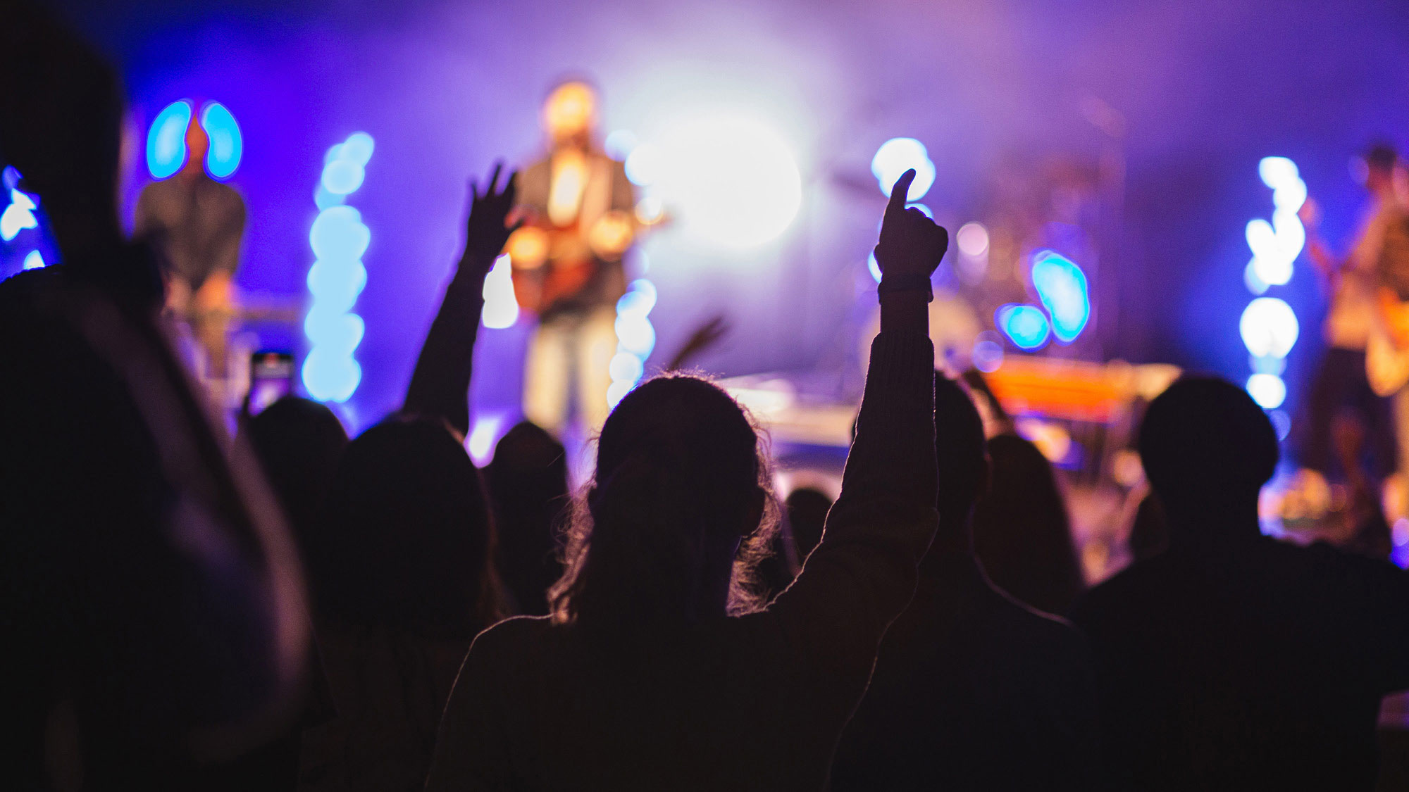 Hands raised during a Night of Worship, which offers an incoming freshman the opportunity to worship in a community.