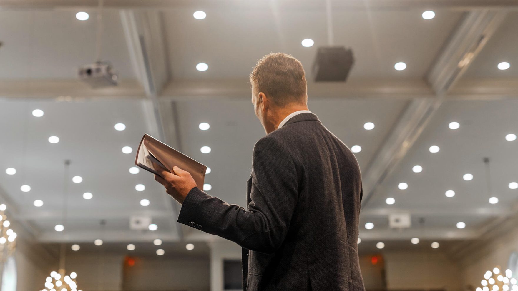 A student of Regent University's D.Min. in Biblical Preaching giving a sermon with a Bible in hand.