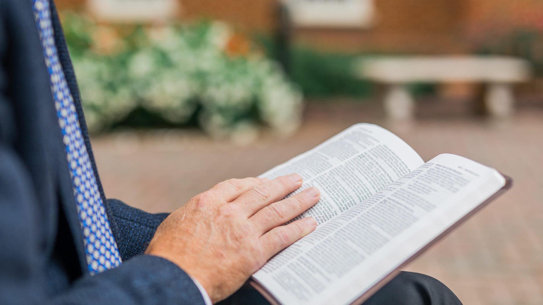 A student reading a Bible in Regent University's MTS in Christian apologetics.