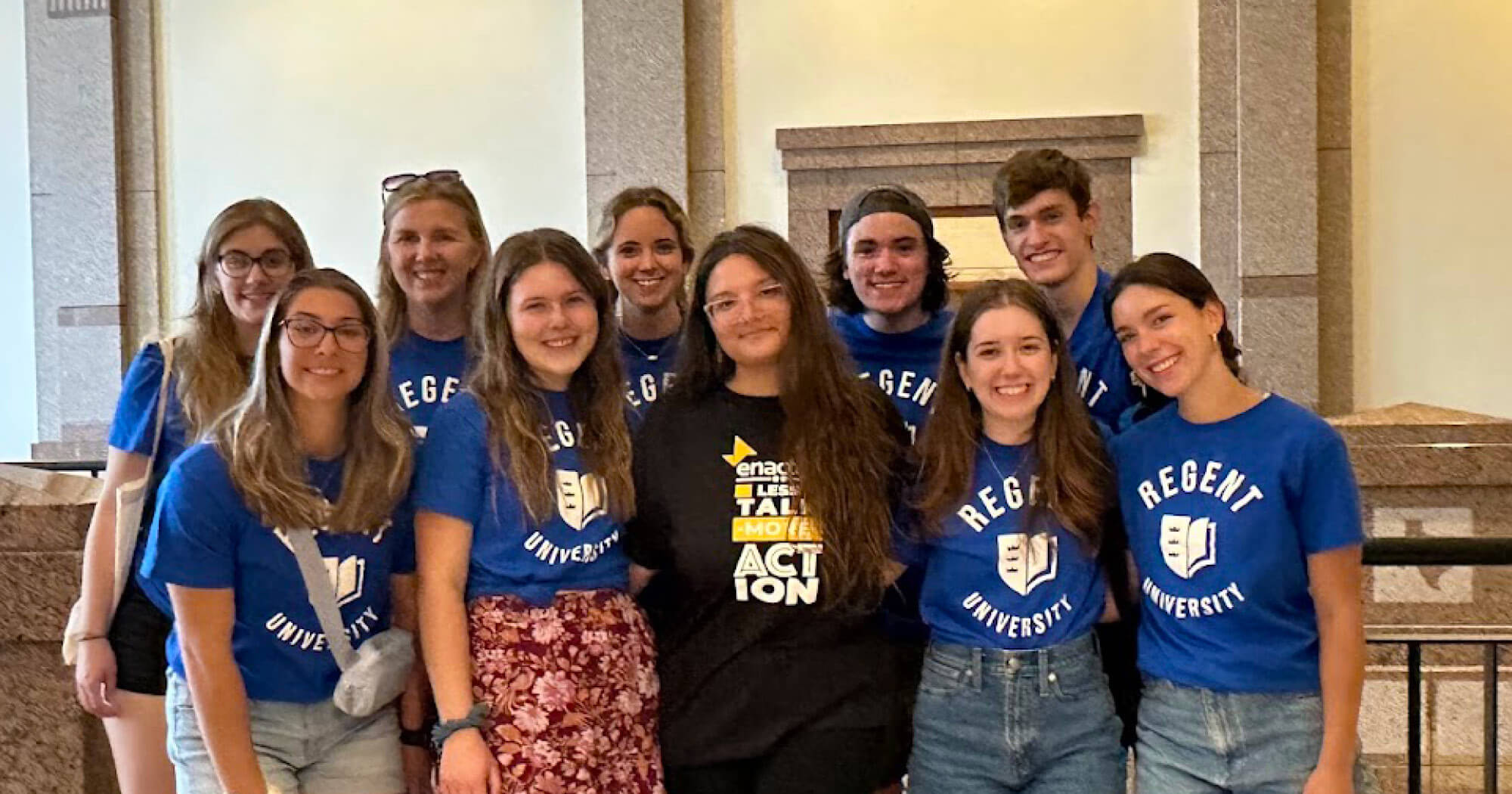 Regent University Enactus team posing together at the National Competition in matching Regent tshirts.