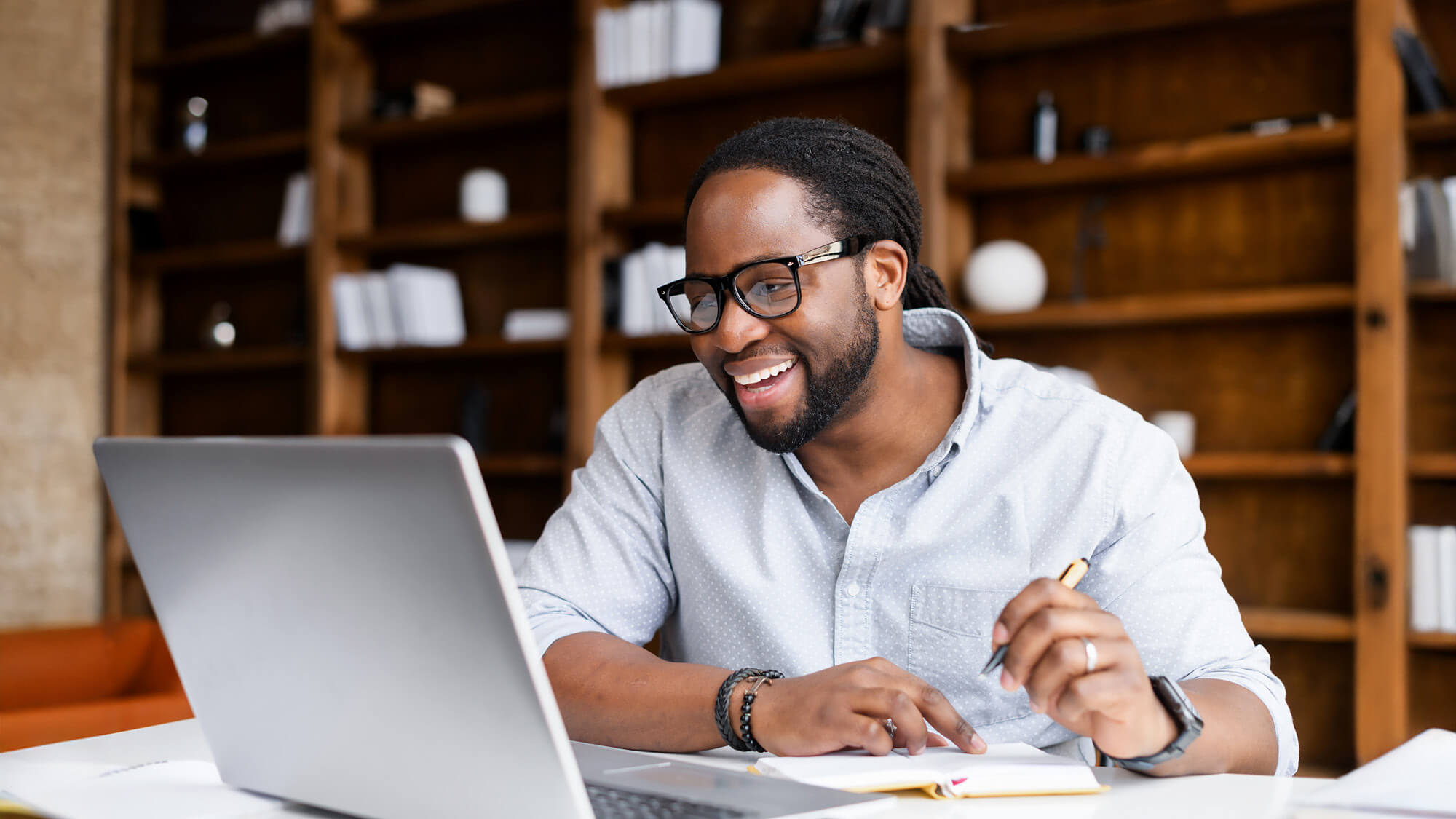 A graduate student on his laptop: Our online bachelor's programs have been ranked as number 1 in Virginia.