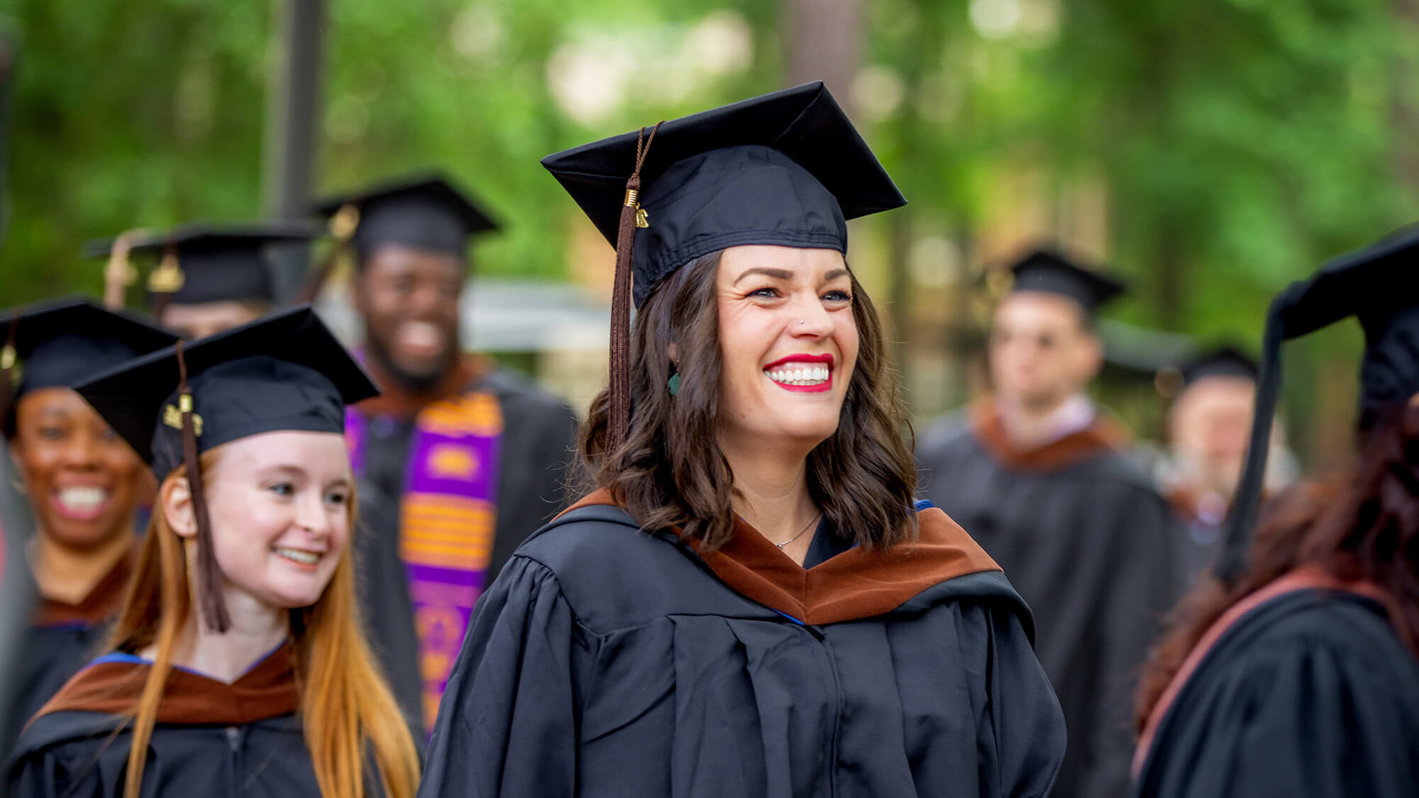 An alumna on graduation day: Earn your degree online at Regent University.