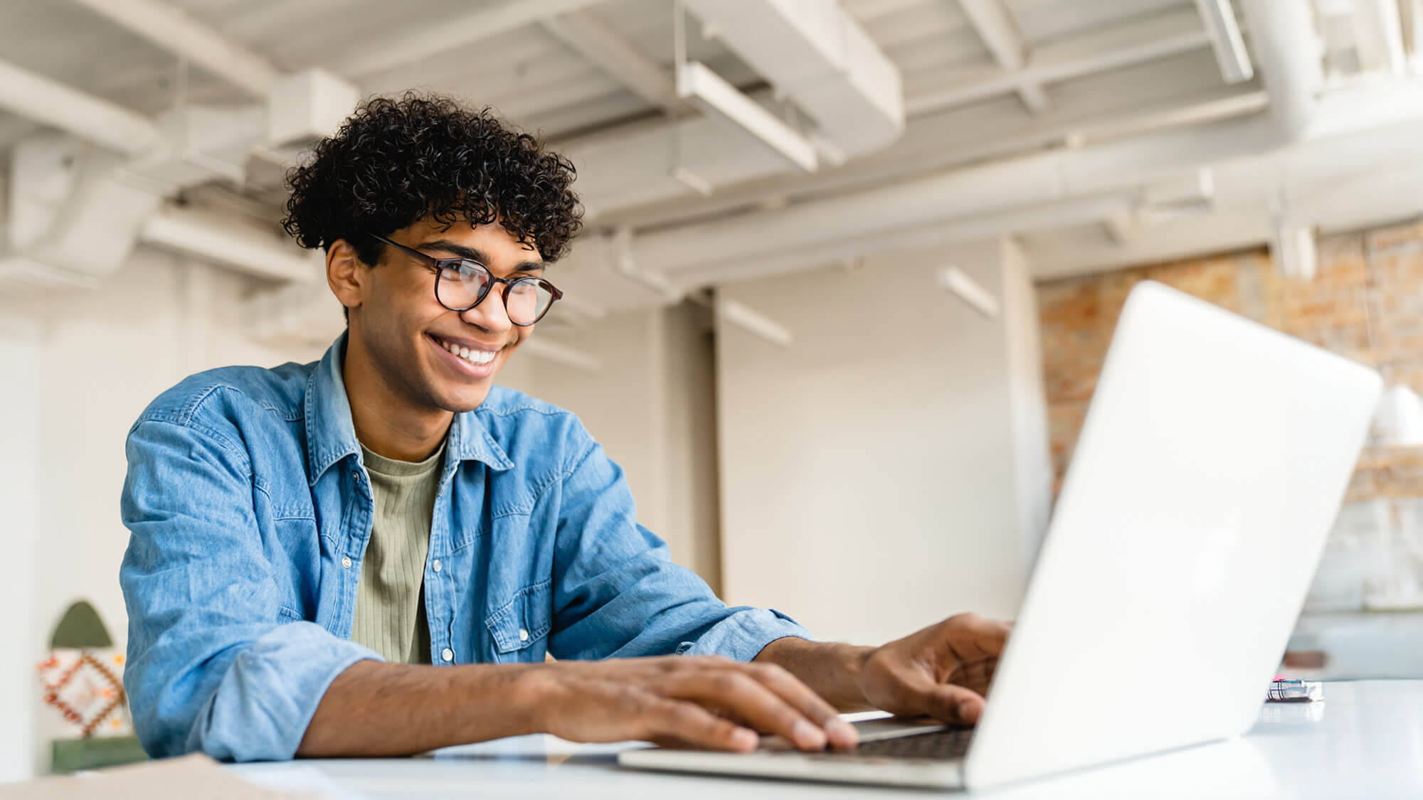 A traditional undergraduate student on his laptop.